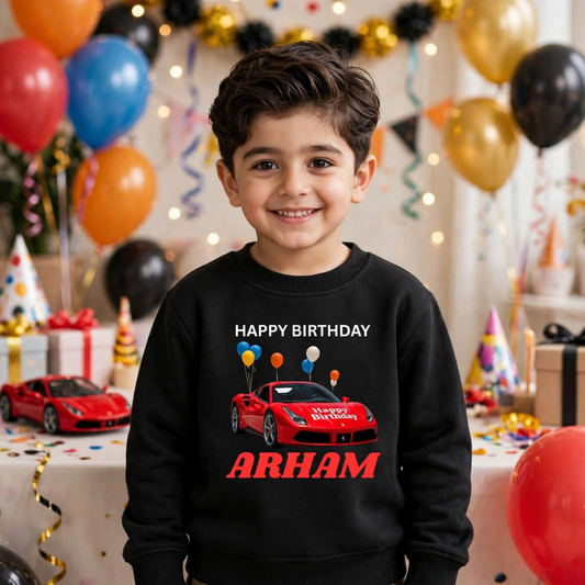 Child wearing black car birthday sweatshirt with Arham lettering