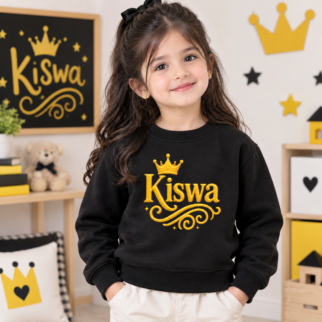 Child wearing black Kiswa crown sweatshirt