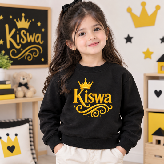 Child wearing black Kiswa crown sweatshirt